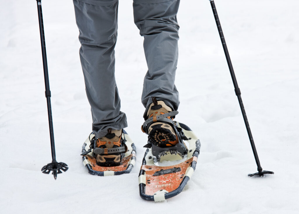 persons legs with snowshoes