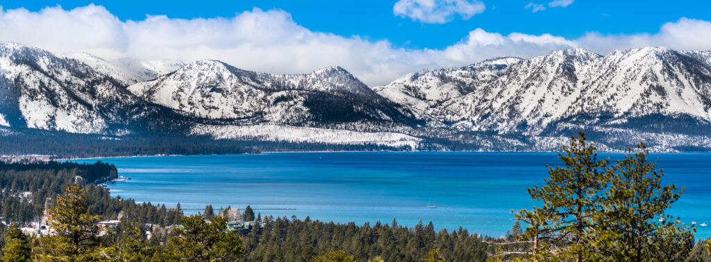 View of Lake Tahoe covered in snow on a sunny clear day.